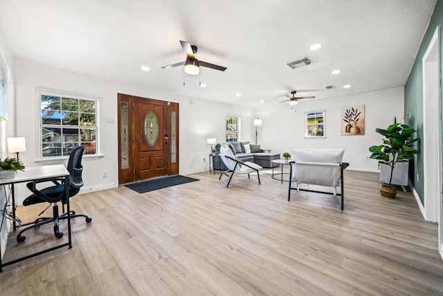 office area with plenty of natural light and light hardwood / wood-style flooring