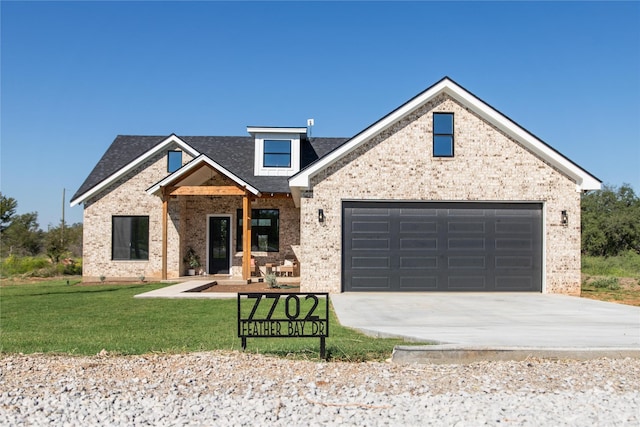 view of front of home featuring a garage and a front yard