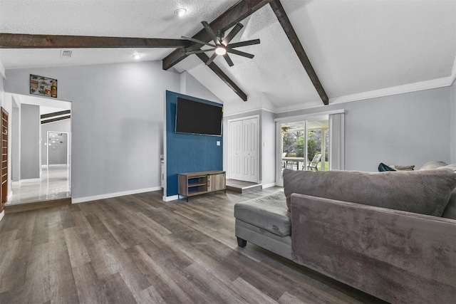 living room with ceiling fan, lofted ceiling with beams, dark hardwood / wood-style floors, and a textured ceiling