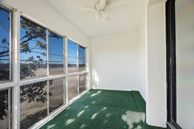 unfurnished sunroom featuring ceiling fan