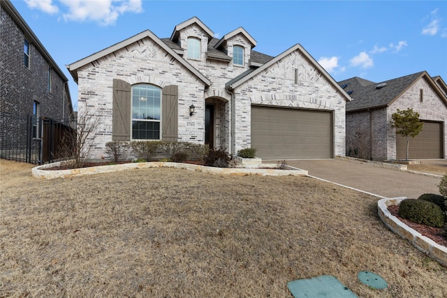 view of front of property with a garage and a front lawn