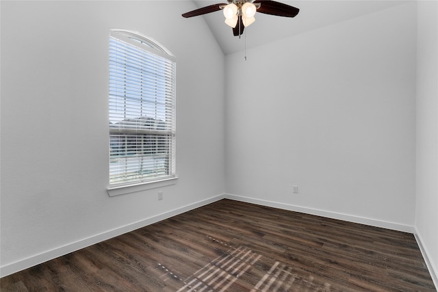 empty room with vaulted ceiling, ceiling fan, and dark hardwood / wood-style flooring