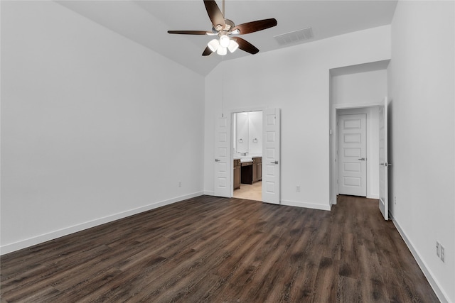 unfurnished bedroom featuring ceiling fan, connected bathroom, dark hardwood / wood-style flooring, and high vaulted ceiling