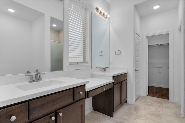 bathroom with an enclosed shower and vanity