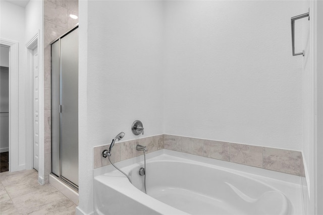 bathroom featuring shower with separate bathtub