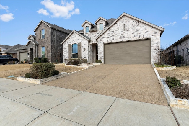 french country style house with a garage