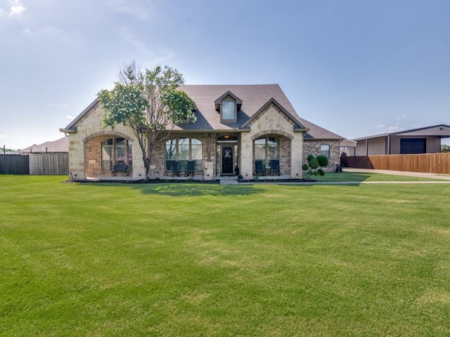 french country style house featuring a front yard