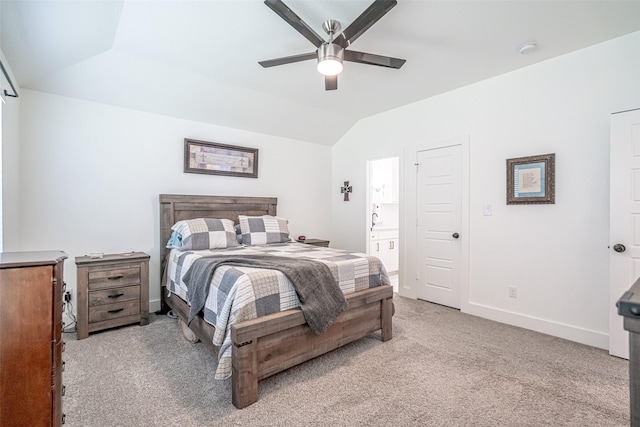 bedroom featuring ceiling fan, lofted ceiling, connected bathroom, and light colored carpet