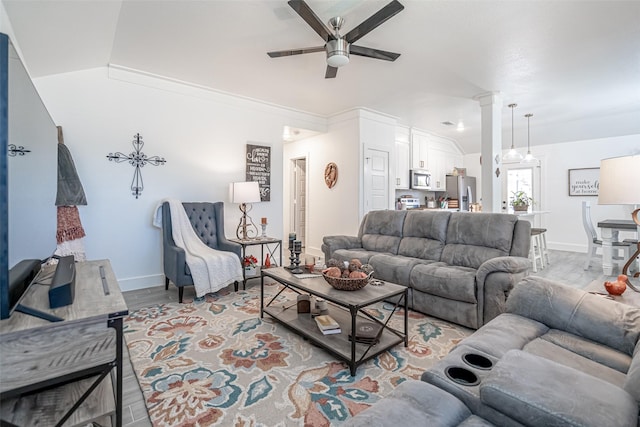 living room featuring ornate columns, lofted ceiling, ornamental molding, ceiling fan, and light wood-type flooring