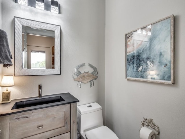 bathroom with vanity and toilet