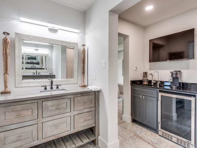 bathroom featuring hardwood / wood-style flooring, vanity, and wine cooler