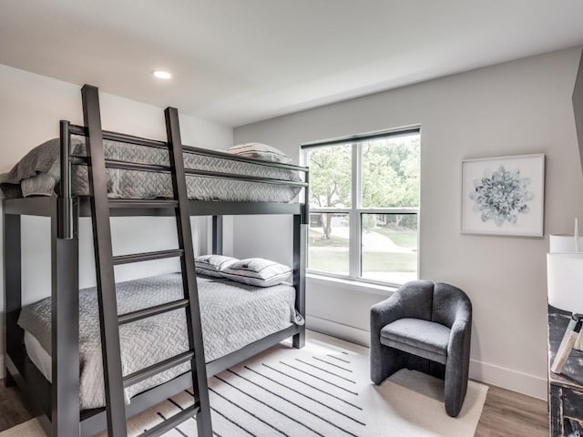 bedroom featuring multiple windows and hardwood / wood-style flooring