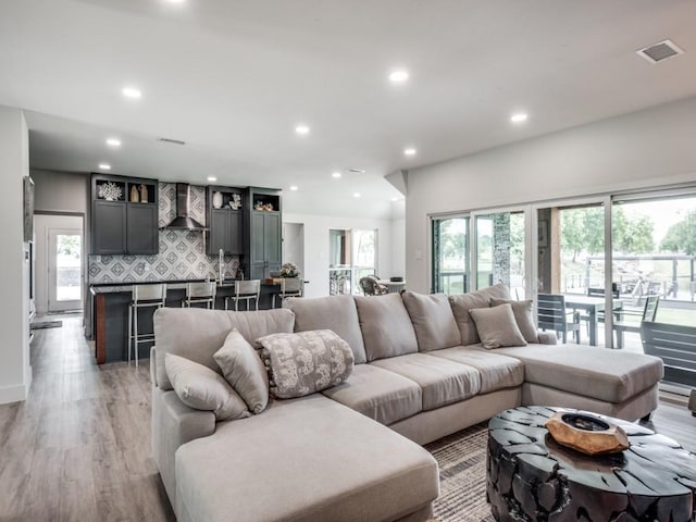 living room with light hardwood / wood-style flooring and a wealth of natural light