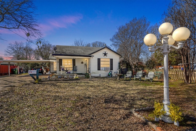 view of front of home with a carport and a porch