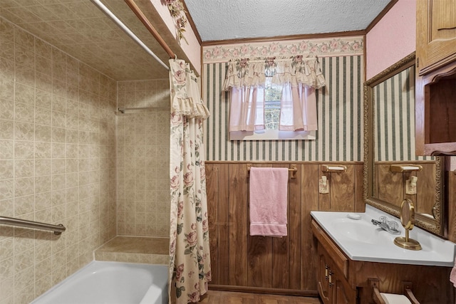 bathroom with vanity, shower / bathtub combination with curtain, and a textured ceiling