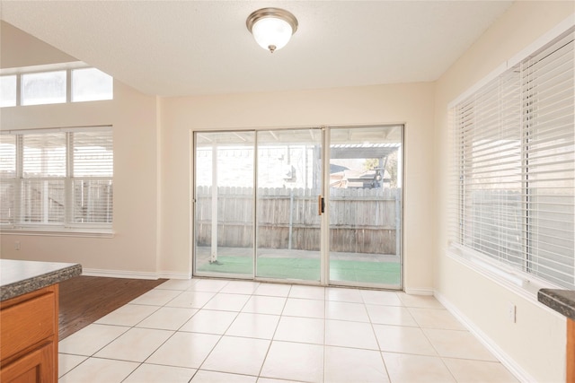 interior space featuring a healthy amount of sunlight and light tile patterned floors