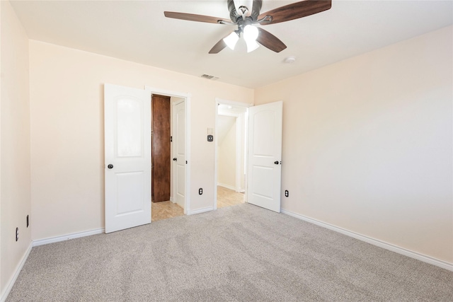 unfurnished bedroom featuring light colored carpet and ceiling fan