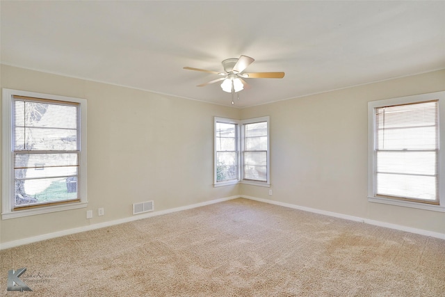 carpeted empty room featuring ceiling fan