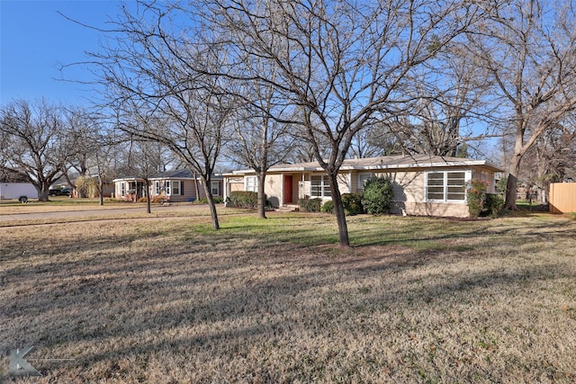 ranch-style house with a front lawn