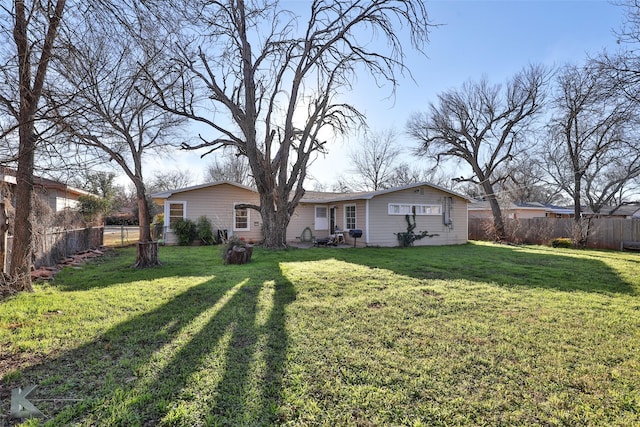 back of property featuring a lawn