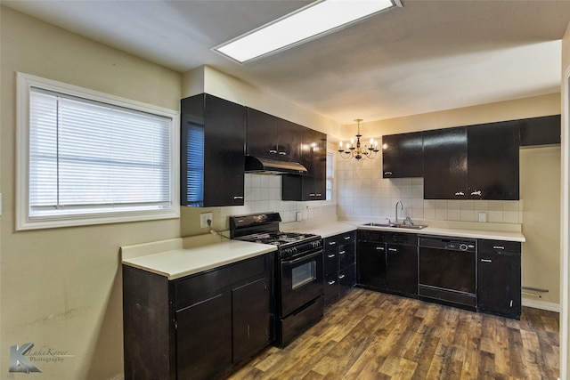 kitchen featuring sink, decorative backsplash, hanging light fixtures, black appliances, and dark wood-type flooring