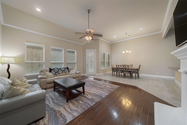 living room with lofted ceiling, crown molding, ceiling fan with notable chandelier, and hardwood / wood-style flooring