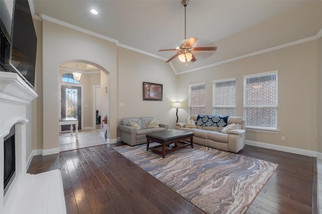 living room featuring crown molding, lofted ceiling, dark hardwood / wood-style floors, and ceiling fan