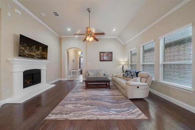 living room featuring crown molding, ceiling fan, dark hardwood / wood-style floors, and vaulted ceiling