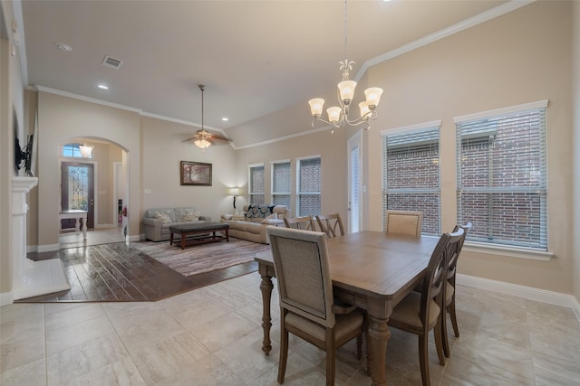 tiled dining space with crown molding and a healthy amount of sunlight