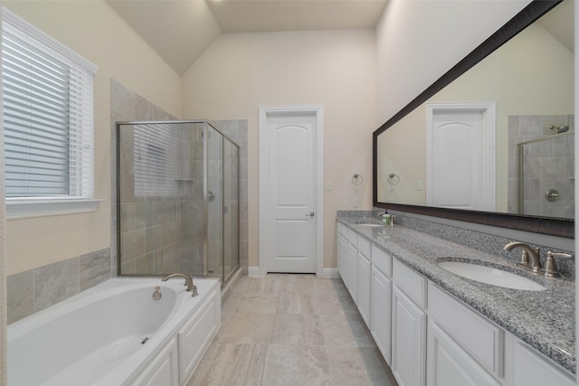 bathroom with walk in shower, vanity, and vaulted ceiling