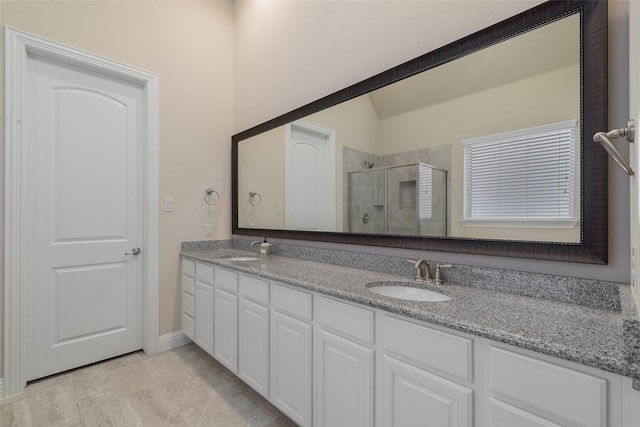 bathroom featuring vanity and an enclosed shower