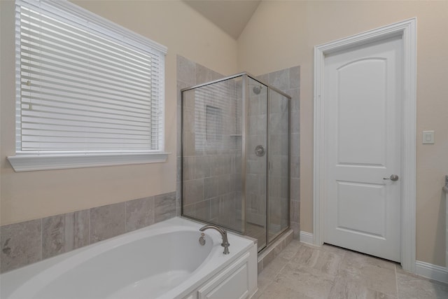 bathroom with shower with separate bathtub and lofted ceiling