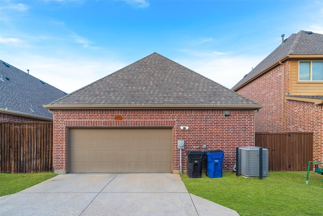 view of side of home with a garage, central AC unit, and a lawn