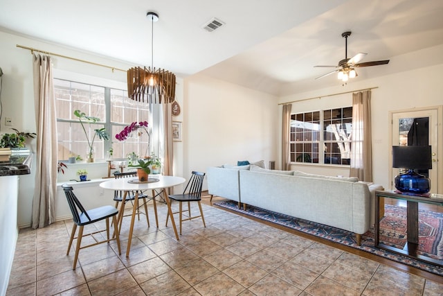 tiled dining room with ceiling fan