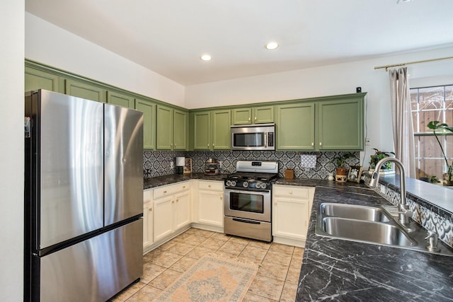 kitchen featuring tasteful backsplash, appliances with stainless steel finishes, sink, and white cabinets