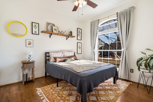 bedroom with ceiling fan and dark hardwood / wood-style flooring