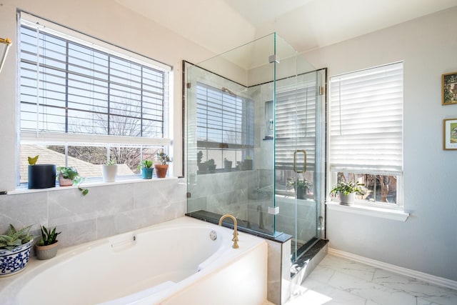 bathroom featuring plenty of natural light and plus walk in shower