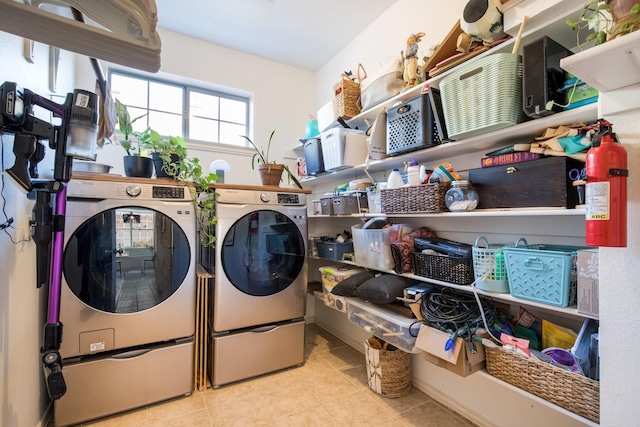 laundry room with washing machine and dryer and light tile patterned flooring