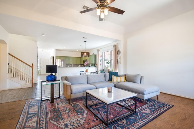 living room with ceiling fan and hardwood / wood-style floors