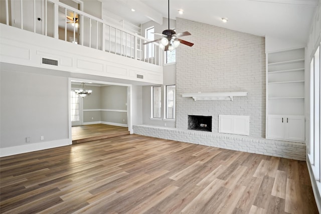 unfurnished living room with ceiling fan, plenty of natural light, a fireplace, and hardwood / wood-style floors