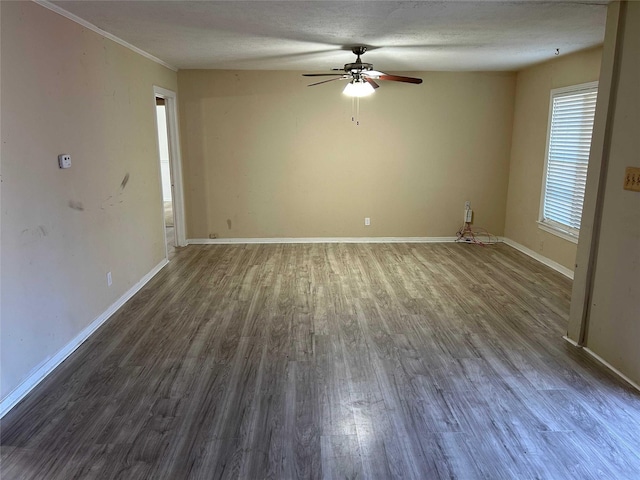 unfurnished room with dark wood-style floors, ceiling fan, a textured ceiling, and baseboards