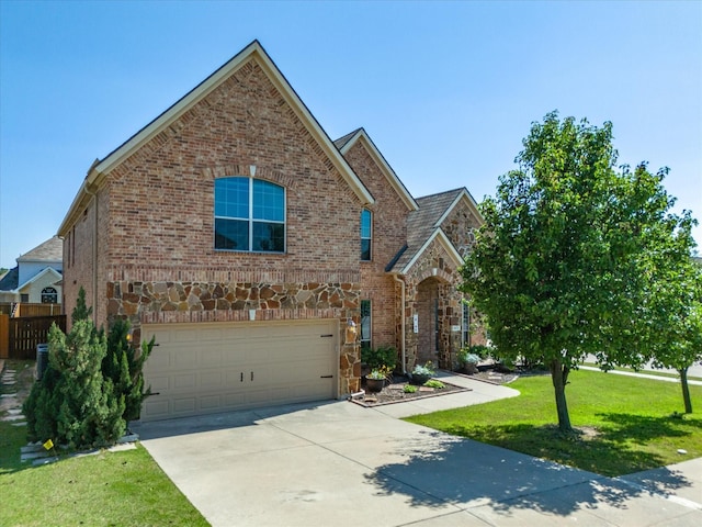 view of front of house featuring a garage and a front lawn