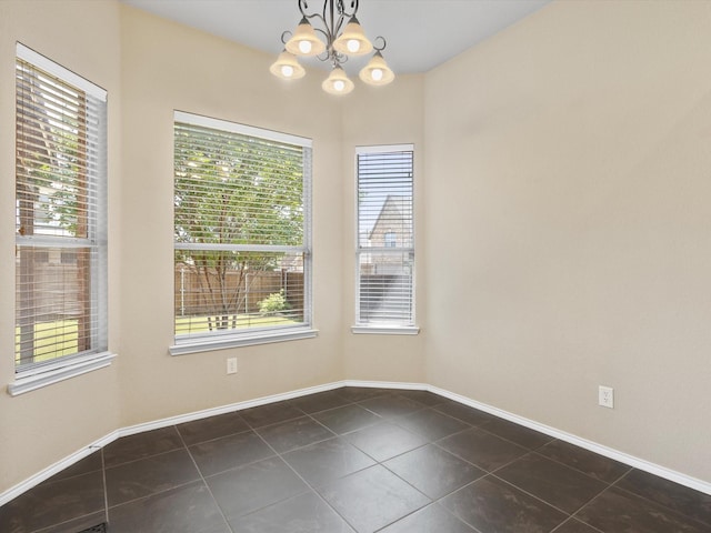 tiled empty room with a chandelier