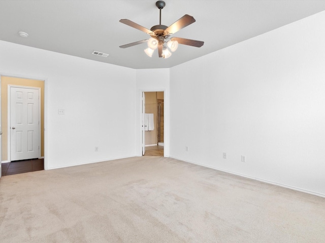 carpeted spare room featuring ceiling fan