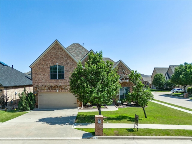 view of front of house with a garage and a front yard