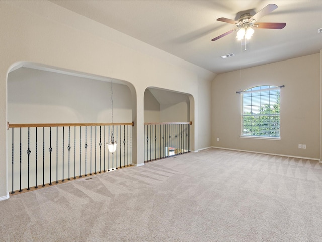 carpeted empty room with ceiling fan and vaulted ceiling