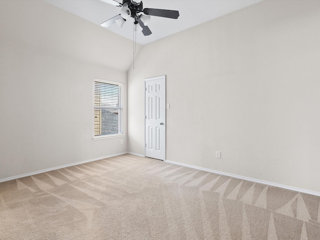 carpeted empty room with lofted ceiling and ceiling fan