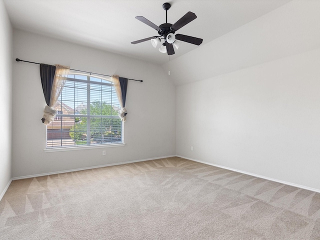 unfurnished room featuring vaulted ceiling, light colored carpet, and ceiling fan