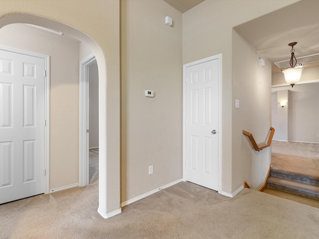 hall featuring light carpet