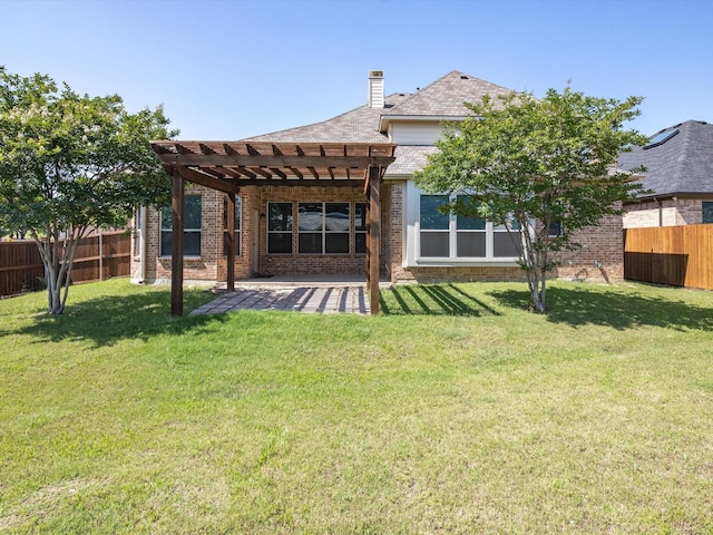 back of property with a lawn, a patio area, and a pergola